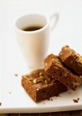 Brownies in front of a cup of coffee