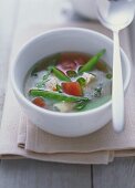 Miso soup with tofu, tomatoes and mangetout peas