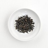 Green tea leaves (Golden Oolong, China) on plate