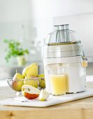 Freshly pressed pear juice with electric juicer