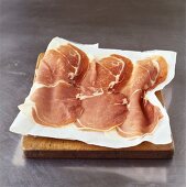 Parma ham, thinly sliced, on paper