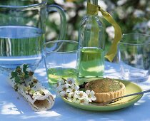 Lime tart and woodruff syrup on table out of doors