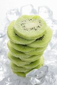 Frozen kiwi fruit slices (in a pile) on ice cubes