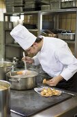 Chef checking a cooked carrot