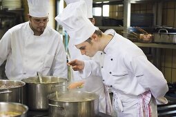 Chef checking a cooked carrot