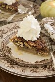 Slice of pecan pie with cream for Thanksgiving (USA)