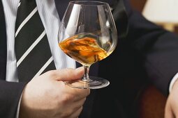 Man swirling cognac in a glass