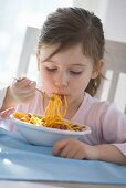 Girl eating spaghetti bolognese