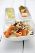 Melon salad with pine nuts and onions