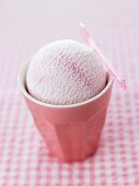 A scoop of fruit ice cream in a beaker