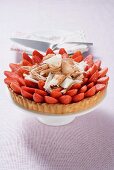 Strawberry tart with chocolate shavings on cake stand