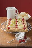 Puff pastry pear and raspberry tart, icing sugar