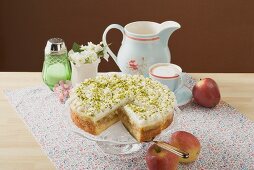 Apple cake with cream and pistachios, coffee, fresh apples
