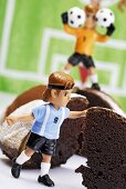 Chocolate cake with footballer and goalkeeper