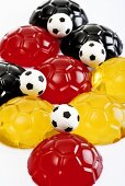 Black, red and yellow jellies in shape of footballs
