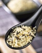 Long-grain rice and wild rice on Asian spoon