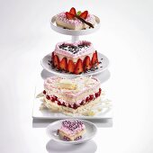 Four heart-shaped sponge cakes with redcurrants or strawberries & cream