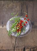 Tomatoes, variety 'Johannisbeere', on glass plate