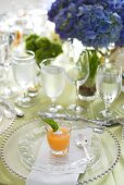 Elegant place-setting with glass of cold soup