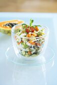 Crab salad with exotic fruit in a glass