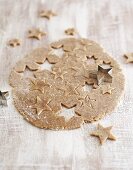 Unbaked cinnamon stars with dough and cutters