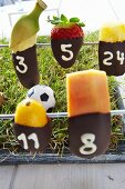 Table football with chocolate-dipped fruit