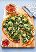 Pizza topped with spinach and quails' eggs