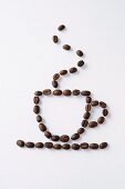 Coffee beans arranged in shape of coffee cup