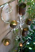 Tealights in old tin cans (garden decorations)
