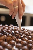 Decorating chocolates with a piping bag