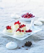 Meringues with cream and pomegranate seeds