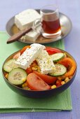 Sweetcorn, cucumber, tomato and red pepper salad with sheep's cheese