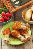 Chicken drumsticks, radishes and bread rolls for a picnic