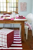A dining table laid in red and white