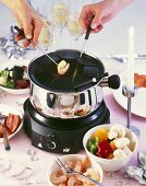 Fondue with shrimps, vegetables and meat