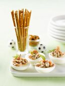 Eggs stuffed with shrimps and dill, salted sticks (football theme)