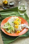 Fish steamed in banana leaf with cucumber salad and mango salsa