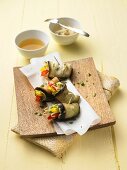 Aubergine rolls filled with peppers and sprouts