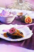 Fried aubergine slices with figs and sauce