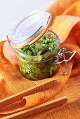 Courgettes with herbs in preserving jar
