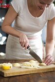 Woman slicing pears on chopping board