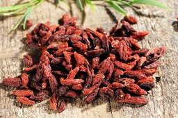 Dried goji berries on wooden background