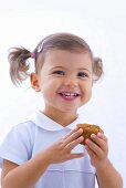 Little girl holding muffin