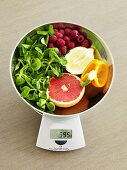Fruit and vegetables (rich in vitamin C) on scales