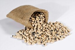 Black-eyed peas spilling out of hessian sack