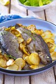 Fried trout with lemon and fried potatoes