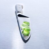 Slices of leek on a kitchen knife