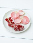 Rosenblütenblätter und Beeren mit Zucker bestreut
