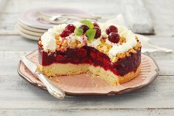 Cherry crumble cake with cream, pieces removed