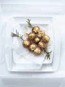 Ham-wrapped figs with ricotta and walnut stuffing on rosemary skewers